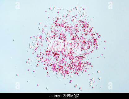 Colored sugar sprinkles background. Sugar sprinkle dots, decoration for cake and bakery, lot of sprinkles on blue background. Top view. Flat lay Stock Photo