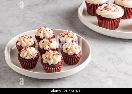 mini red velvet cupcakes in a white dish on a light background Stock Photo