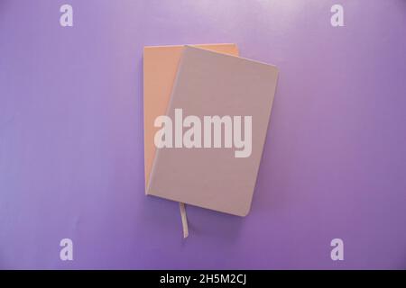 Two notebook, top view of two notebook isolated on purple background. Stock Photo