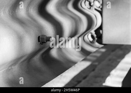 Abstract industrial background with bolts and shadows pattern, close-up black and white photo Stock Photo