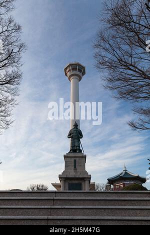 Busan, South Korea - March 14, 2018: Busan Tower and statue of Admiral Yi Sun-shin at Yongdusan Park, vertical photo Stock Photo