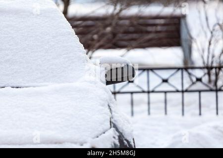 A vehicle is under snow, front view with side mirror Stock Photo