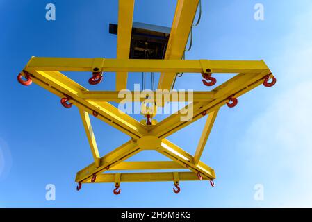 Special crane for lifting boats in the marina seen from below against the sky. Stock Photo