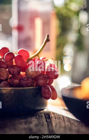 Small bowl filled with grapes in the sun. High quality photo Stock Photo