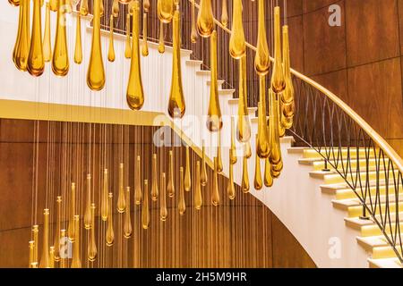 Dushanbe, Tajikistan. August 12, 2021. Decorative glass chandelier and spiral stairs. Stock Photo