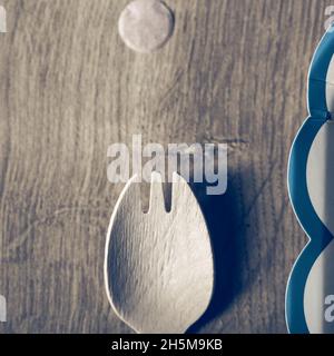 Wooden fork spoon close up still on a wooden table Stock Photo