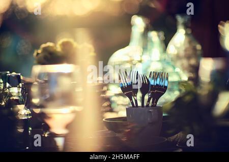 cutlery standing on a festive table in the bright sun. High quality photo Stock Photo