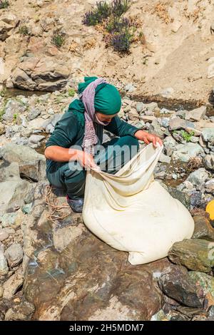 Rabot, Gorno-Badakhshan Autonomous Province, Tajikistan. August 14, 2021. Churning milk into butter in rural Tajikistan. Stock Photo