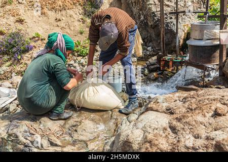 Rabot, Gorno-Badakhshan Autonomous Province, Tajikistan. August 14, 2021. Churning milk into butter in rural Tajikistan. Stock Photo