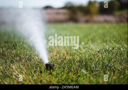 winterizing a irrigation sprinkler system by blowing pressurized air through to clear out water Stock Photo