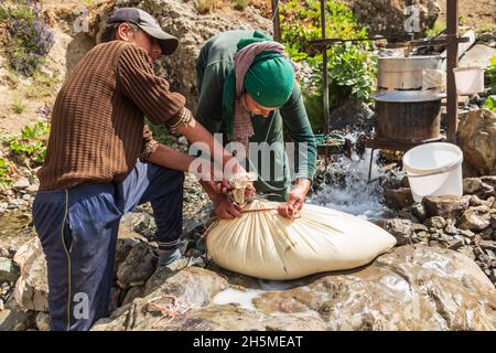 Rabot, Gorno-Badakhshan Autonomous Province, Tajikistan. August 14, 2021. Churning milk into butter in rural Tajikistan. Stock Photo