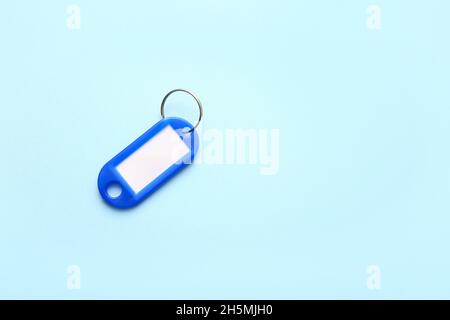 Plastic key tag on blue background Stock Photo