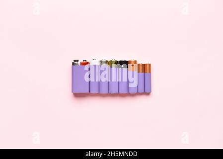 Alkaline batteries on pink background Stock Photo