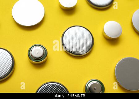 Lithium button cell batteries on yellow background, closeup Stock Photo