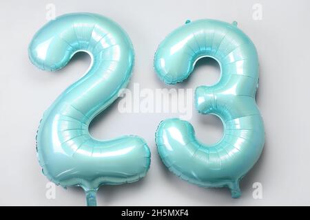Figure 23 made of green balloons on light background Stock Photo
