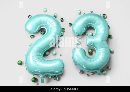 Figure 23 made of balloons and Christmas balls on light background Stock Photo
