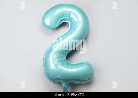 Balloon in shape of figure 2 on light background Stock Photo