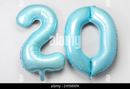 Figure 20 made of green balloons on light background Stock Photo