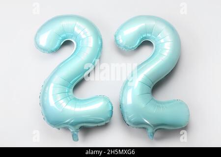 Figure 22 made of green balloons on light background Stock Photo