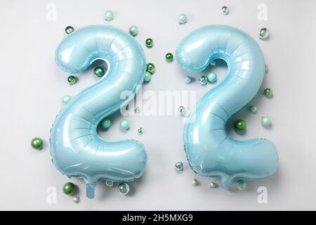 Figure 22 made of balloons and Christmas balls on light background Stock Photo
