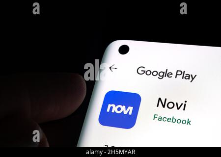 FACEBOOK Novi app digital wallet in Google Play seen on smartphone screen and fingerr pointing at it. Stafford, United Kingdom, November 10, 2021 Stock Photo