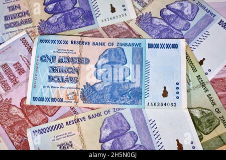Lot of Zimbabwe hyper inflation dollar bills including the One Hundred Trillion Dollars, the currency is now worthless money Stock Photo