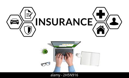 The concept of various types of insurance as a business. Insurance agent working on laptop Stock Photo