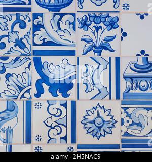 Fragment of building wall with colorful ceramic wall tiles. Abstract decorative background. Azulejos, traditional ornate Portuguese architecture. Stock Photo