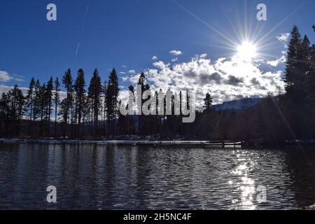 Lake Tahoe with Sun Peaking Over Clouds Stock Photo