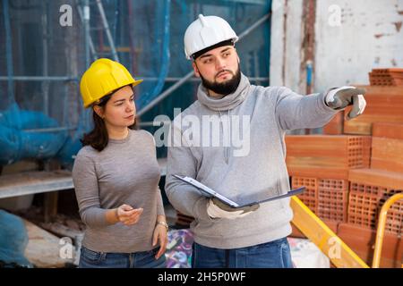 Architect and contractor discussing construction plan Stock Photo