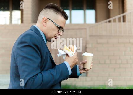 Coffee and sandwich take away for lunch. snack for businessman who walking on the way to work office and having breakfast en route. Business people li Stock Photo