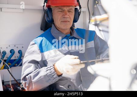 Smart manufacturing concept, engineer uses tablet computer to control construction online. Stock Photo