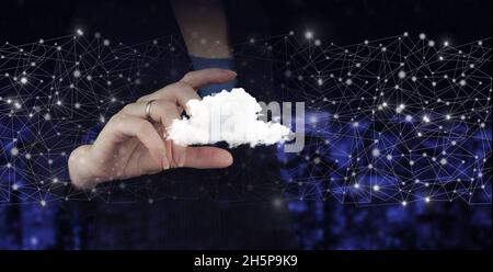 Modern cloud technology. Integrated digital web. Hand hold digital hologram cloud sign on city dark blurred background. Cloud computing technology int Stock Photo