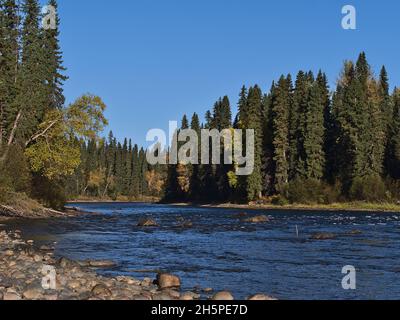 Beautiful view of Bowron River near Yellowhead Highway (16) west of Prince George, British Columbia, Canada on sunny day in autumn season with rocks. Stock Photo