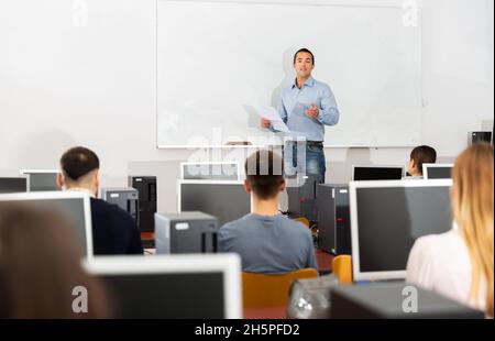 Male trainer giving presentation to audience Stock Photo