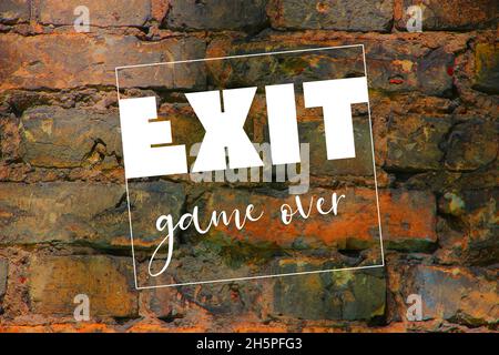 White exit word and game over. letters on brick wall. gaming concept Stock Photo