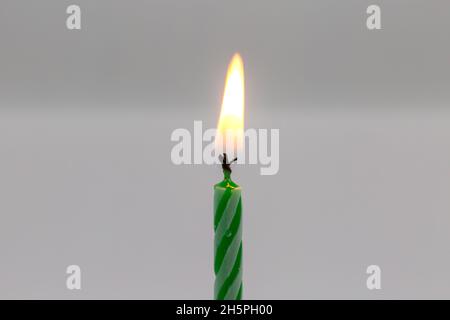 Green birthday candle on white background Stock Photo