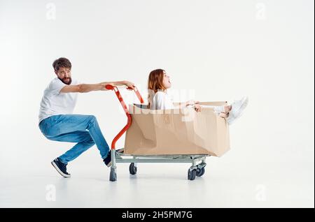 a young couple ride a cart entertainment isolated background Stock Photo