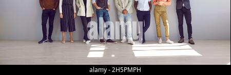 Banner with group of people in smart casual clothes standing in office or studio Stock Photo