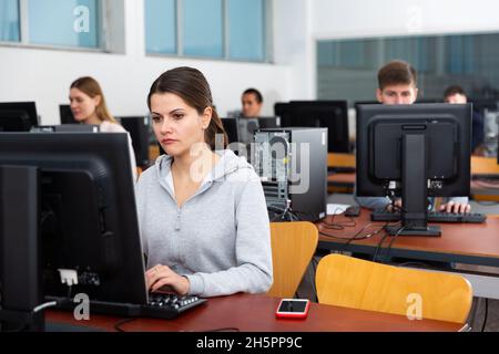 Computer lessons for adults in classroom Stock Photo