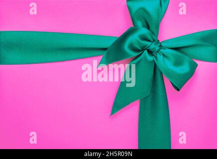 Bright pink gift box with green ribbon. Stock Photo