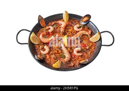 Pan of spanish paella on white background. Isolated with clipping path Stock Photo