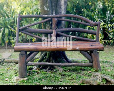 a chair made of wood in a garden Stock Photo