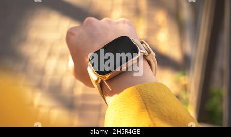 Woman uses modern smart watch outdoors close-up view photo Stock Photo