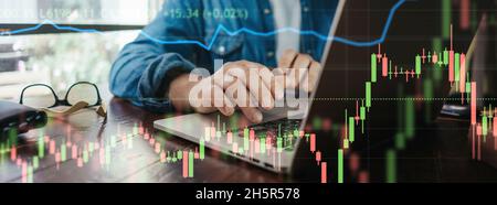 Trader at home, working on laptop with graphs and diagrams. Business man analyzing indexes, financial chart, trading online, investment data on crypto Stock Photo