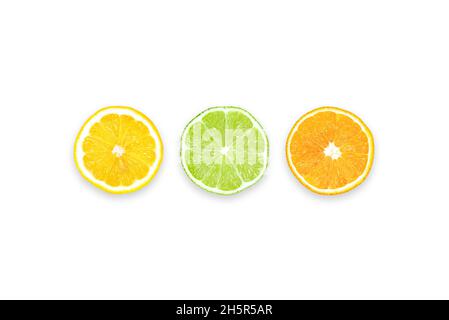 Lemon, Lime and Orange: Three slices of different citrus fruits. Table top view, flat lay, copy space. Stock Photo