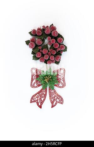 Beautiful red bow gift with holly leaf wreath christmas decoration isolated on white background. Xmas ornaments with traditional garland red berry and Stock Photo