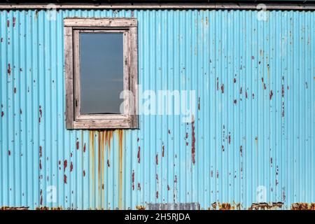 Colourful corrugated iron wall of a building on Yell in the Shetland Islands. Stock Photo