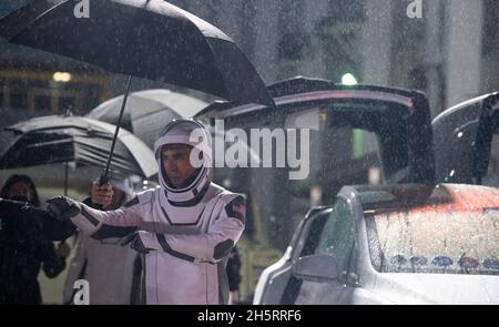 NASA astronaut Raja Chari, wearing a SpaceX spacesuit, points towards friends and family as he prepares to depart the Neil A. Armstrong Operations and Checkout Building for Launch Complex 39A to board the SpaceX Crew Dragon spacecraft for the Crew-3 mission launch, Wednesday, Nov. 10, 2021, at NASA's Kennedy Space Center in Florida. NASA's SpaceX Crew-3 mission is the third crew rotation mission of the SpaceX Crew Dragon spacecraft and Falcon 9 rocket to the International Space Station as part of the agency's Commercial Crew Program. Chari, NASA astronauts Tom Marshburn, Kayla Barron, and ESA Stock Photo