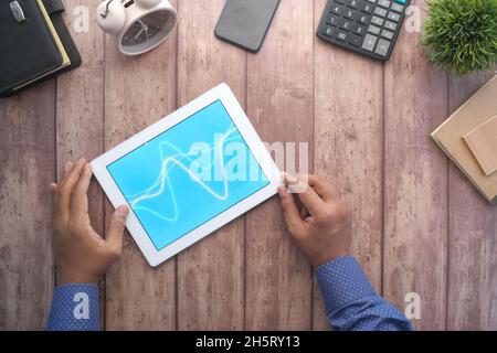 analyzing stock market data on digital tablet  Stock Photo